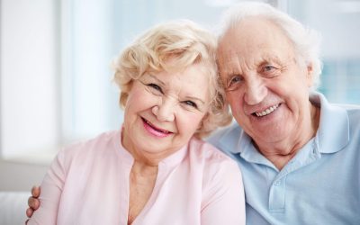 Happy elderly couple smiling warmly together.